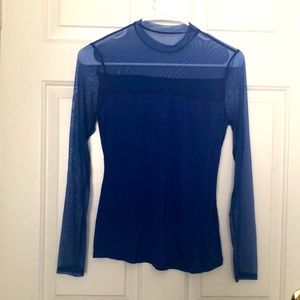 A sweater with mesh top and sleeves